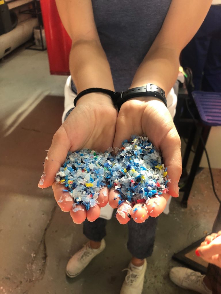 Hand holding shredded plastic